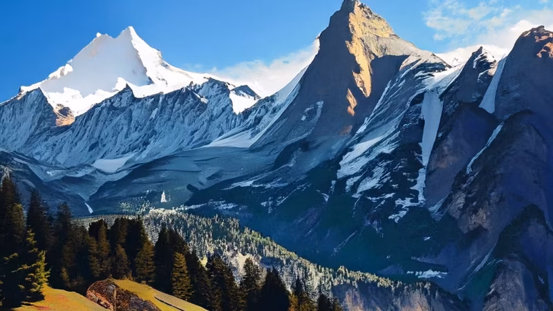 Majestic snow-capped mountain peaks towering over a lush green forest, symbolizing the vast reach and comprehensive network of Orioninsist.